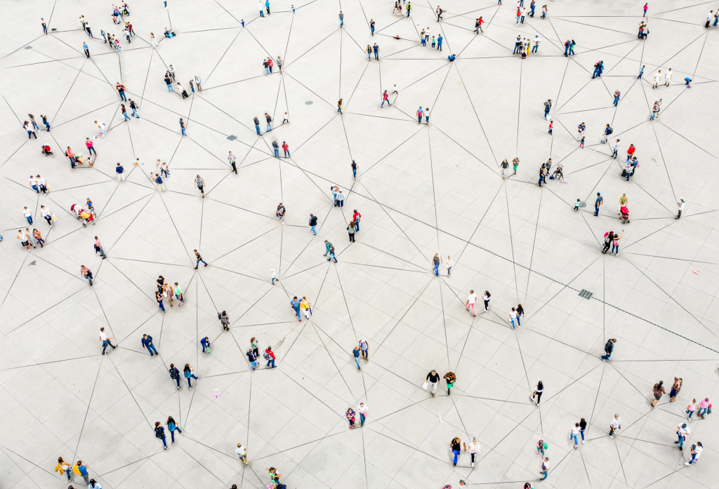 networking image of birds eye view of people standing on a white floor in spread out groups connected by lines