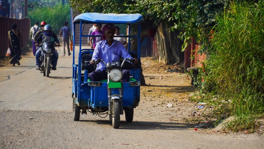 Kirti Nagar, Delhi, India blue battery rickshaw photo on Delhi road 